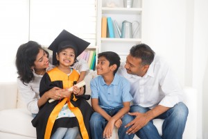 Preschool graduate surrounded by proud family