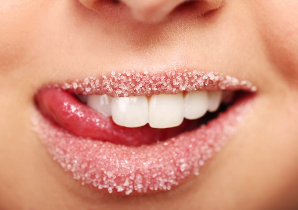 closeup of a woman's lips covered in sugar