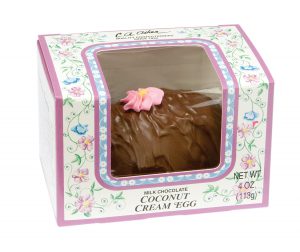 4-oz Milk Chocolate Coconut Cream Egg whole in package with clear window to show outside of egg and edible small pink flower decoration on top of chocolate .